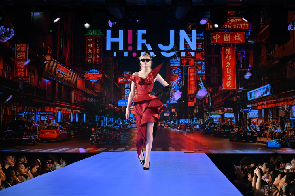 Woman walking down the stage of runway 7 fashion show